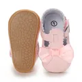 Detail showing pink baby girl princess shoes with decorative silk bow and soft non-slip sole - Pink