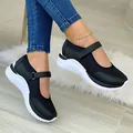 Detail view of black fly-knit Mary Jane sneakers with Velcro strap and thick white sole - 35 / Black