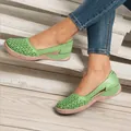 Detailed close-up of green laser-cut flat sandals showing intricate floral hollow-out patterns. - 35 / Green