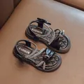 Elegant black girl's sandals featuring sparkly rhinestones and decorative bow accents - Black