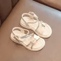 Elegant beige girls sandals featuring sparkling rhinestone straps and a cute bow detail - Beige