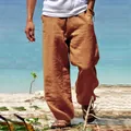 Detail of men's loose casual linen pants in earthy brown color for beach wear - S / Bottoms / Earthy Yellow