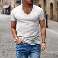 Detail view of a men's classic white V-neck short sleeve casual T-shirt styled with blue jeans - White
