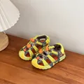 Detailed macro shot of kids' breathable sports sandals in vibrant yellow and grey colors - Yellow