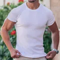 Close-up detail of the white ribbed fabric on a men's slim-fit fitness crew neck T-shirt. - M / Tops / White