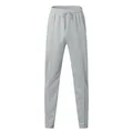 Close-up detail of light grey men's waffle knit casual pants with drawstring elastic waist - Light Gray