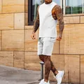 Side view detail of a white men's sports vest and matching sweatshorts on a model - M / Top And Bottom / White