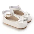 Elegant white patent leather baby girl shoes with bow and soft sole detail macro view - Inner Length 11cm / 64g / White