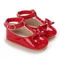 Close-up of red patent leather baby girl walking shoes with a bow and soft sole design - Inner Length 11cm / 64g / Red