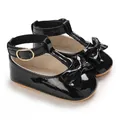 Close-up of black patent leather baby shoes with bow detail and soft sole. - Inner Length 11cm / 64g / Black