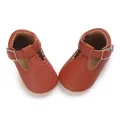 Top-down detail of brown leather T-strap baby shoes with scalloped edges and soft sole - Dark Brown