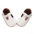 Detailed macro view of white baby walking shoes with scalloped edges and soft rubber soles - Inner Length 11cm / White