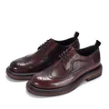 Detailed view of dark brown leather brogue shoes with classic wingtip pattern - Dark Brown