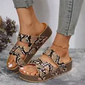 Close-up of women's snakeskin platform sandals with crossover straps and thick sole - Snake Print