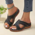 Detail view of women's black wedge sandals with hollow out design and white stitching. - 35 / Black