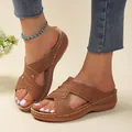 Detailed view of brown platform sandals with perforated straps and white stitching - Tan