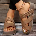 Stylish women's brown wedge sandals with woven cross-straps and a thick platform sole - Brown