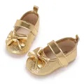 Detailansicht goldener Baby-Prinzessinnenschuhe für Mädchen mit einer Schleife auf Weiß - Gold