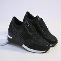 Detail view of black wedge sneakers featuring glossy finish and glitter mesh fabric - 35 / Black