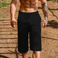 Detailed view of men's black breathable linen cotton cropped leisure shorts worn outdoors - Black