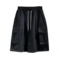 Close-up detail of black men's cargo shorts featuring a drawstring and side pockets - S / Bottoms / Black