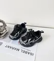 Close-up of black and white patterned children's sports shoes on a fashion magazine - Size 22 (14.5cm) / Black (Thick Mesh)