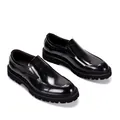 Detailed view of shiny black patent leather loafers with thick lug soles - 38 / Black