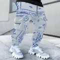 Close-up of white cargo pants with blue paisley print and multi-pocket utility design. - Grey Blue / S