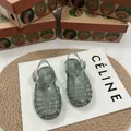 Vista dettagliata dei sandali intrecciati con glitter Mini Melissa per bambini - Verde Scintillante