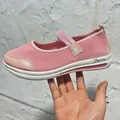 Detail view of pink mesh Mary Jane flat shoes with star strap and white wedge sole. - 35 / Pink