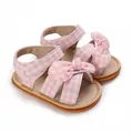 Detailed macro view of pink checkered baby girl sandals featuring a cute bow decoration - 11cm / Pink