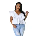 Close-up detail of white V-neck peplum top featuring dramatic ruffle fly sleeves - S / Tops / White