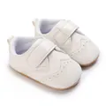 Close-up of white faux leather baby boy walking shoes with non-slip rubber soles - White