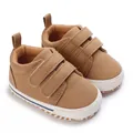 Detailed close-up view of brown canvas baby sneakers with double hook-and-loop straps. - Dark Brown