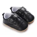 Close-up of black faux leather baby walker shoes with brogue detailing and rubber sole - 11cm/64 / Black