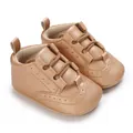 Detailed macro view of rose gold baby soft sole sneakers with pebble leather texture - 11cm/64 / Gold