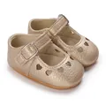 Close-up of golden baby princess shoes with heart cutouts and non-slip rubber soles. - Gold