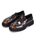 Close-up detail shot of men's brown patent leather platform loafers with chunky black soles - 38 / Tan Gold