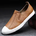 Men's brown leather casual slip-on loafers featuring a stylish white rubber toe cap design - 38 / Brown