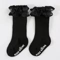 Detailed view of black kids' lace princess socks with anti-slip rubber grip lettering. - Size S (0-6 Months) / Black