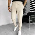 Close-up of men's beige waffle knit drawstring pants in a modern room setting - M / Bottoms / Light Khaki
