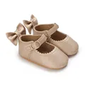 Detailed view of gold baby girl walking shoes with heel bow and metal buckle closure. - Gold