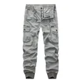 Detail view of men's casual grey cargo jogger pants with multiple pockets and drawstring. - 29 / Bottoms / Light Gray