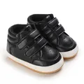 Detailed view of black faux leather infant boy walking shoes featuring velcro straps - Black