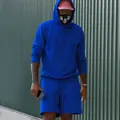 Streetwear detail of men's bright blue fleece hoodie and matching drawstring shorts set. - S / Top And Bottom / Sapphire Blue