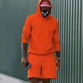Full view of men's orange fleece hoodie and matching shorts set on model outdoors - S / Top And Bottom / Orange