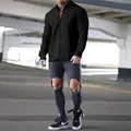 Detail shot of a black waffle knit zip-up jacket for men in an urban setting - Black
