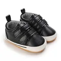 Close-up detail of black baby walking shoes with dual velcro straps and anti-slip sole - Black