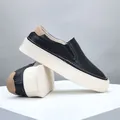 Classic men's black leather slip-on loafers with thick white platform sole design - Black