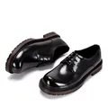 Detailed view of polished black leather Derby shoes with classic brogue wingtip patterns. - 38 / Black